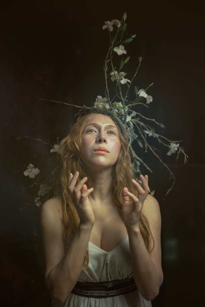 Elegant portrait of a woman with a flower crown, embodying medieval art style and nature's beauty.