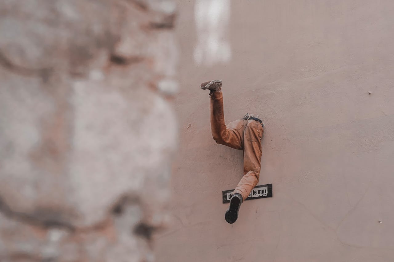 Unique artistic display with only legs emerging from a wall in Lyon, France.
