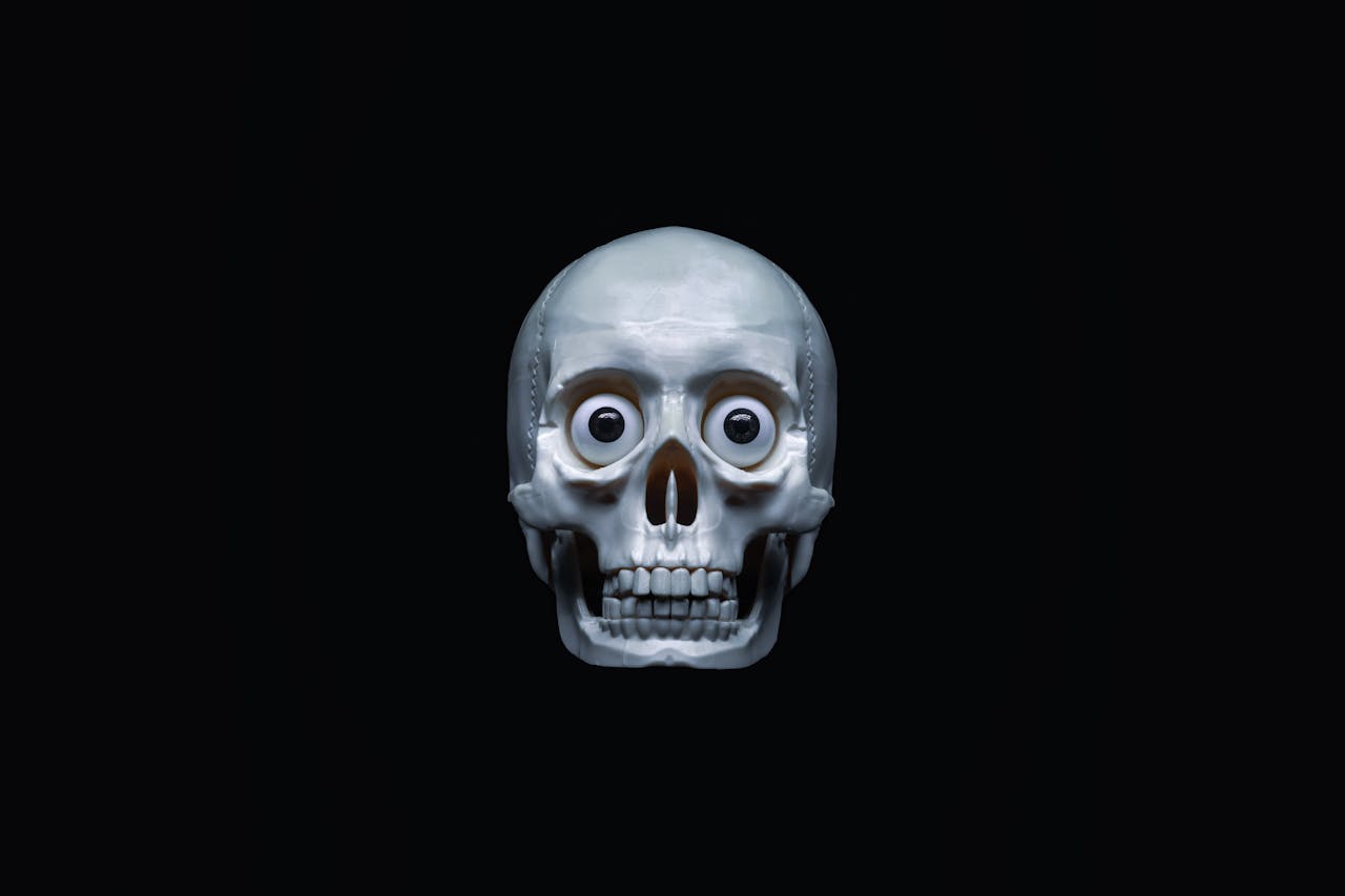 A spooky skull with googly eyes, ideal for Halloween themes and creepy art projects.